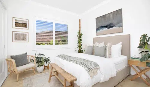 Hardwood shutters in a bedroom providing privacy.