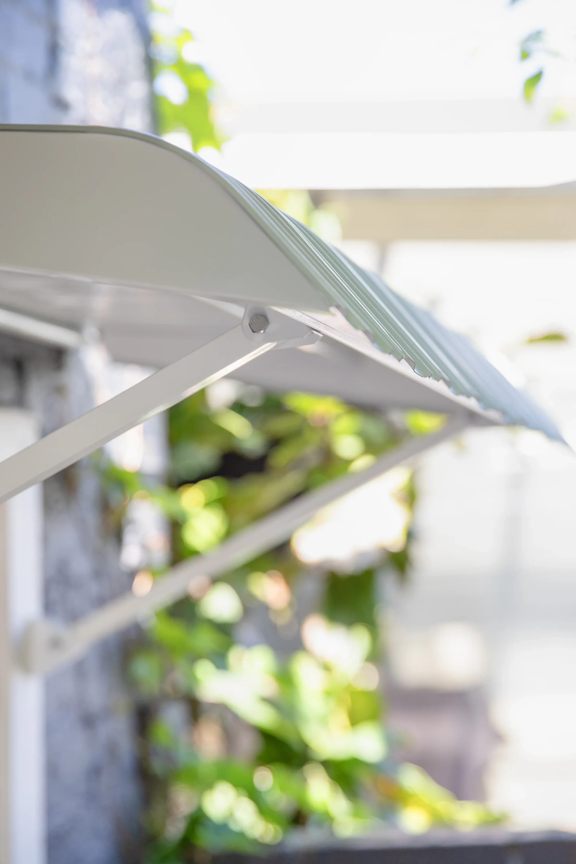 Close up show of fixed steel awning in white