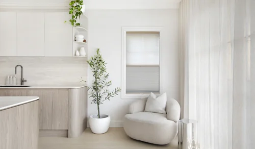 honeycomb blind and sheer curtains in light-filled Sydney kitchen nook with timber cabinetry and round armchair