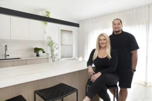 Michelle and Marty Taupau in their renovated Sydney kitchen with honeycomb blinds and sheer curtains